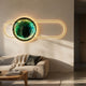 Vitreon 3D Emerald Crystal Porcelain with Gold Frame Wall Art by Giant Sculptures, illuminated above a cream sofa with throw and dark cushion in a living room.