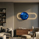 Vitreon Cobalt Blue Flat Crystal Porcelain Wall Art with gold LED-lit oval frame, mounted above a walnut sideboard in a modern living room.
