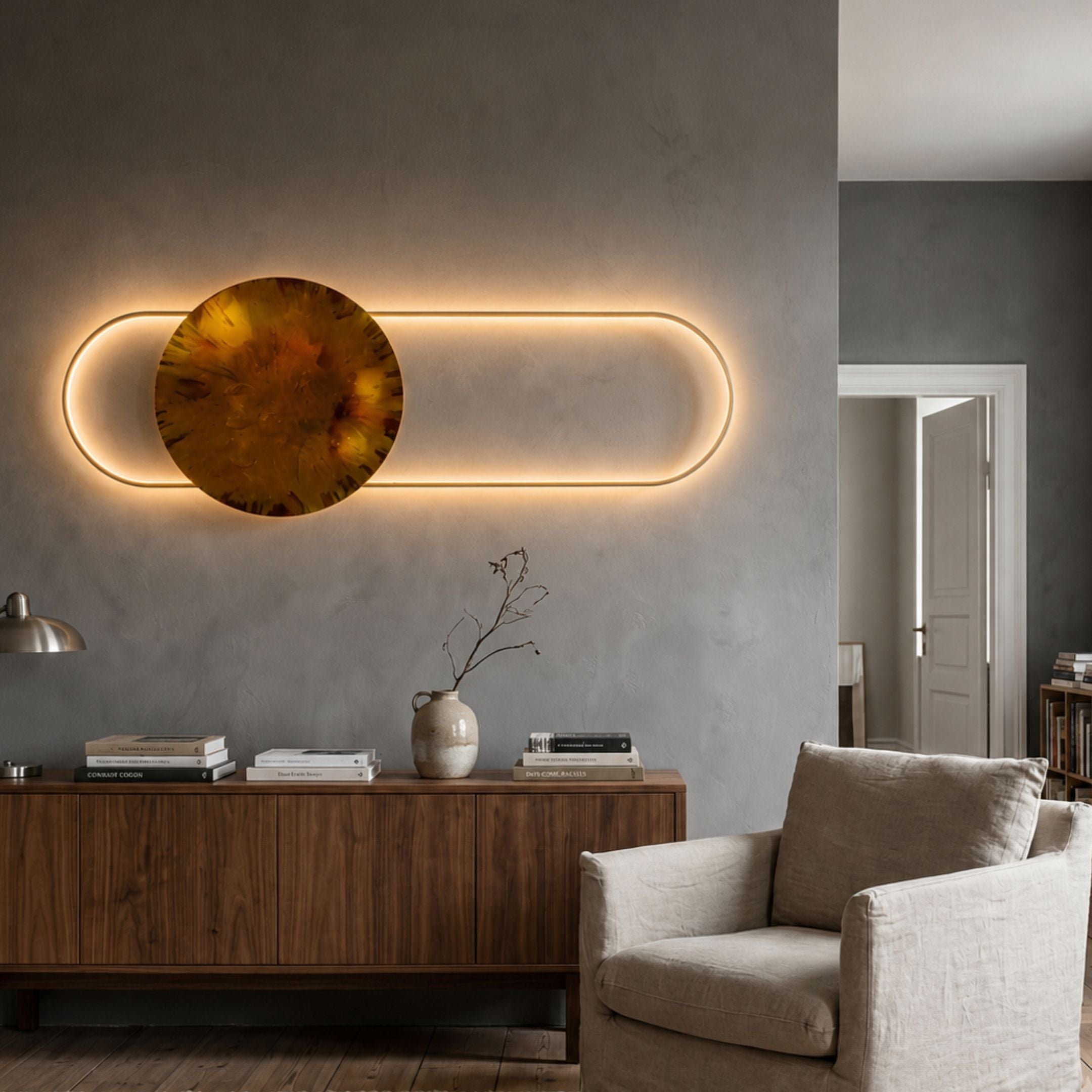 Vitreon Amber Flat Crystal Porcelain With Gold Frame Wall Art mounted above a walnut sideboard in a grey living room, its lit oval frame glowing around the amber disc.