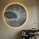 Earthlight Midnight Mist 3D Textured Oil Painting LED Wall Art by Giant Sculptures with circular mesh on grey gradient, glowing above a bookshelf and sofa.