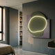 Gleam Olive Serenity 3D Leather LED Wall Art by Giant Sculptures, an olive blob with white neon outline on a grey leather backdrop, mounted in a bedroom.