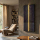 Eternia Midnight Textured Oil Painting LED Wall Art by Giant Sculptures, displayed on a textured wall beside a linen chair, bookshelf, and wooden coffee table.