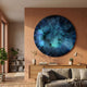Genesis Twilight 3D Resin Crystal Porcelain LED Wall Art by Giant Sculptures, a large blue-green swirling disc mounted on a terracotta wall above a wooden sideboard.