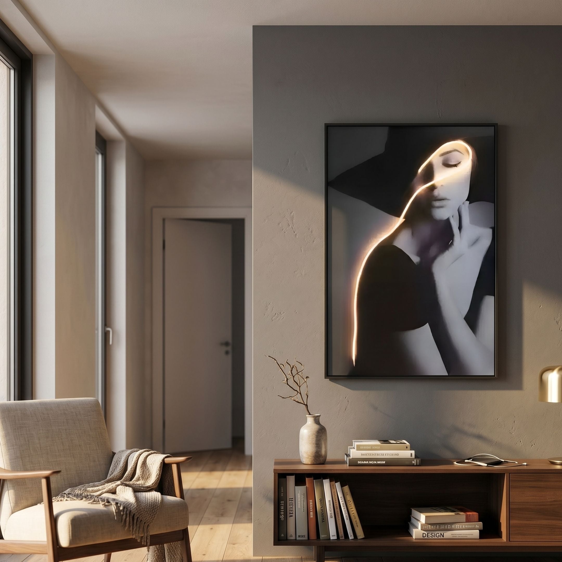 Sylva Noir Muse Canvas LED Wall Art by Giant Sculptures, a monochrome portrait with a golden LED line curving across her face, displayed above a wooden console in a sunlit living room.