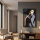 Sylva Noir Muse Canvas LED Wall Art by Giant Sculptures, a monochrome portrait with a golden LED line curving across her face, displayed above a wooden console in a sunlit living room.