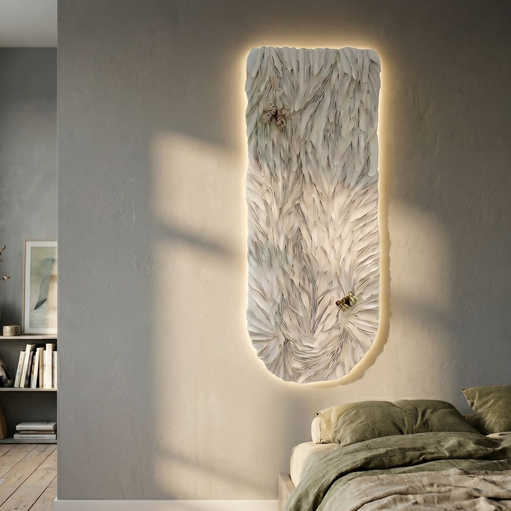 Blossom Serenity White Leather 3D LED Wall Art with layered feather-like petals and seashell accents, backlit on a grey bedroom wall beside an olive bed.