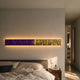 Textura 3D Purple and Gold Leather Design Wall Art by Giant Sculptures, a long horizontal marbled bar backlit above a bed with a globe lamp nightstand.