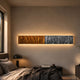 Textura 3D Amber And Silver Leather Design Wall Art mounted above a bedside table in a warm bedroom, with backlighting highlighting its wavy two-tone surface.