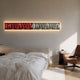 Textura 3D Red And Silver Leather Design Wall Art by Giant Sculptures mounted with backlighting above an upholstered bed, beside a tan leather chair.
