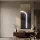 Arcolume I Neutral Gradient Geometric LED Wall Art by Giant Sculptures, mounted above a walnut console with vase and lamp in a modern minimalist living room.
