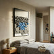 Obscura Black & Blue Geometric 3D Wooden Wall Art by Giant Sculptures displayed above a linen-dressed bed with a ceramic lamp on an oak nightstand.