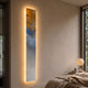 Chroma Amber Textured Layers LED Wall Art Canvas by Giant Sculptures, a tall vertical piece with amber-gold, blue and white swirls glowing on a bedroom wall.