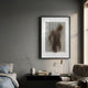 Illusive Standing Figure Wood Carving 3D Wall Art by Giant Sculptures, framed above a black console with brass lamp in a grey-walled bedroom corner.
