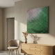 Reflexion Green Gradient Cube Mosaic 3D Wooden Wall Art by Giant Sculptures mounted above a wooden sideboard with a chair and dried pampas in a neutral room.