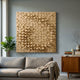 Orbila Circular Flow Wooden Spheres 3D Wall Art by Giant Sculptures, mounted on a grey wall above a grey sofa with wooden sideboard and fiddle leaf plant.
