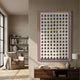 Artiora Pink Edge & Wood Block Modular Grid 3D Wall Art with white house-shaped blocks on a pink panel, displayed above a wooden console beside a reading nook.