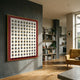 Artiora Red Edge & Wood Block Modular Grid 3D Wall Art by Giant Sculptures displayed on a grey wall in a modern living room with bookshelves and kitchen view.