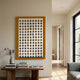 Artiora Gold Edge & Wood Block Modular Grid 3D Wall Art by Giant Sculptures displayed above a walnut console with books and vase in a bright neutral hallway.