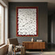 Artiora Red Edge & White Abstract Wooden Shard 3D Wall Art with gold border displayed above a wooden sideboard and armchair in a grey-walled room.