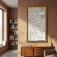 Forma Gold-Edge & White Geometric 3D Wooden Vertical Wall Art displayed above a wooden sideboard in a terracotta-toned room with bookshelves and window.
