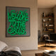 Urbanic Green Welcome Script 3D Wooden Graffiti Wall Art by Giant Sculptures, framed on a beige living room wall beside a bookshelf and leather chair.