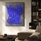 Urbanic Blue Welcome Script 3D Wooden Graffiti Wall Art by Giant Sculptures displayed in a modern living room beside a dark bookshelf, sofa, and chair.