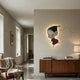 Enigmo Playful Cartoon Character Wooden Wall Art by Giant Sculptures, mounted with backlight glow above a walnut sideboard in a neutral living room.
