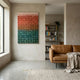 Stratiform Multitone Sunset Gradient Wood Mosaic 3D Wall Art with peach, coral, and teal tiles displayed in a minimalist living room with tan leather sofa.