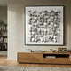 Cubitara White Abstract Wood Cluster 3D Wall Art by Giant Sculptures in a black frame above an oak console with magazines, beside a bookshelf.