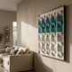 Tessera White & Aqua I Geometric Wood 3D Wall Art by Giant Sculptures mounted above a beige linen sofa in a Nordic-style living room with a tall book tower.