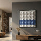 Tessera White & Blue II Geometric Wood 3D Wall Art by Giant Sculptures mounted on a grey wall above a wooden console with a vase and lamp in a modern living room.
