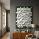 Axion White Wood Cluster & Emerald Green Edge 3D Wall Art displayed above a wooden sideboard with books and a lamp in a grey-walled living room.