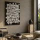 Axion White Wood Cluster & Black Edge 3D Wall Art displayed in a modern living room above a coffee table, beside a stone plinth with dark vase.