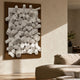 Axion White Wood Cluster & Deep Oak Edge 3D Wall Art mounted on a living room wall above a beige sofa, white cylindrical forms on a dark oak panel.