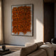 Oratoria Orange Scripted Wood Carving 3D Wall Art by Giant Sculptures displayed above a cream sofa in a warm minimalist living room with wood accents.