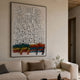 Oratoria Multicolour Scripted Wood Carving 3D Wall Art hung above a cream sofa in a neutral living room, with white cursive script over red, yellow, blue, and green accents.
