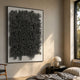 Oratoria Charcoal Grey Scripted Wood Carving 3D Wall Art by Giant Sculptures displayed above a nightstand in a sunlit bedroom with a dome lamp.