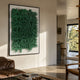 Oratoria Green Scripted Wood Carving 3D Wall Art mounted in a sunlit modern living room above a brown leather sofa, near a wooden chair and open kitchen.