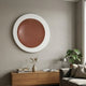 Aetherial Rosewood Glossy Circular Symmetry 3D Wall Art by Giant Sculptures mounted above a wooden sideboard in a Nordic living room with monstera plant.
