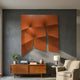 Contours Bold Orange Elastic Fabric 3D Wooden Wall Art by Giant Sculptures mounted on a charcoal wall above a walnut sideboard with plant, books, and armchair.