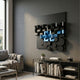 Nocturna Black & Blue Modular Wooden Hand-Painted 3D Wall Art by Giant Sculptures mounted on a grey wall above a console with books in a modern living room.