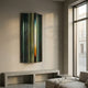 Illumina Green Colourful Vertical Wooden Hand-Painted 3D Wall Art by Giant Sculptures mounted above a concrete bench in a sunlit modern living room.