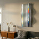 Illumina Chrome Colourful Vertical Wooden Hand-Painted 3D Wall Art with wavy grey, white, yellow, red and blue stripes above a mid-century sideboard.