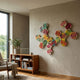 Spectra V Multicoloured Interwoven Hexagonal Frame 3D Wall Art by Giant Sculptures mounted on a beige wall above a mid-century wooden bookshelf and potted plant.