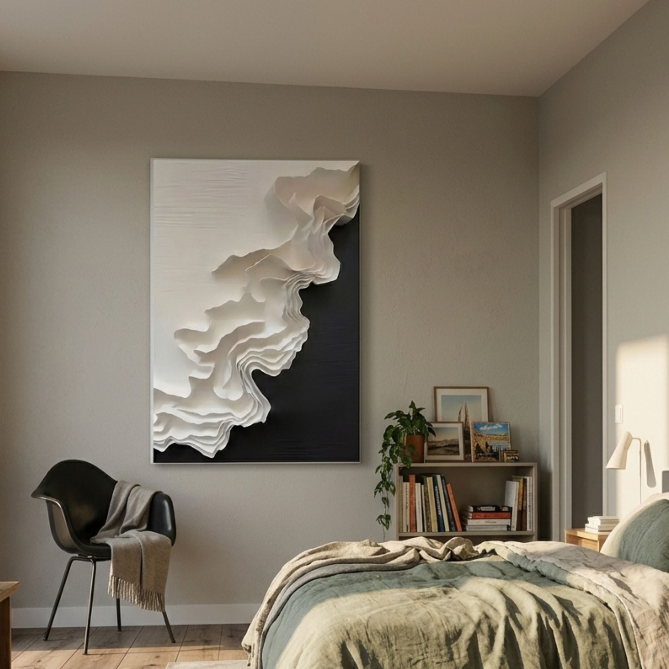 Stratura I Black & White Layered Paper Canvas Wall Art by Giant Sculptures displayed in a modern bedroom above a black chair, beside a bookshelf and bed.