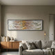 Fluenta Sunlit Ripple Linear Cardboard 3D Wall Art by Giant Sculptures in black frame above a wooden sideboard and grey sofa in a warm modern living room.