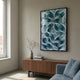 Filigree Turquoise Swirl Quilling Paper Wall Art by Giant Sculptures in a black frame, hung above a walnut sideboard with vase and books in a sunlit living room.