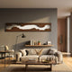 Stratara Dark Brown Wood Carving Mirror Linear Wall Art by Giant Sculptures mounted above a floating shelf and beige sofa in a warm modern living room.