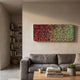 Chromatica Rectangular Radiant Red & Green Rolled Paper 3D Wall Art mounted above a grey sofa in a neutral living room with bookshelves nearby.