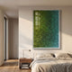 Chromatica Vertical Lush Green Gradient Paper 3D Wall Art by Giant Sculptures mounted above a wooden nightstand and linen bed in a sunlit modern bedroom.